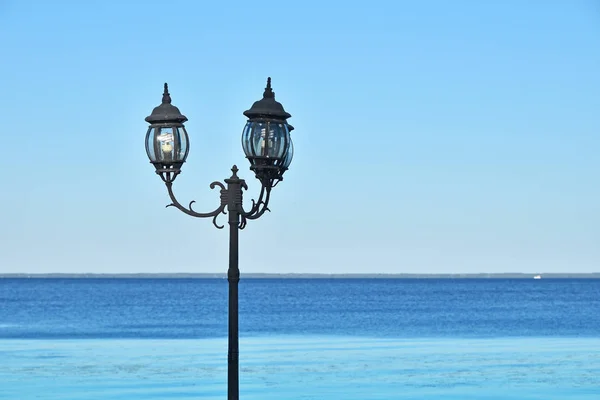 Стара старовинна вулична лампа над синім морем — стокове фото