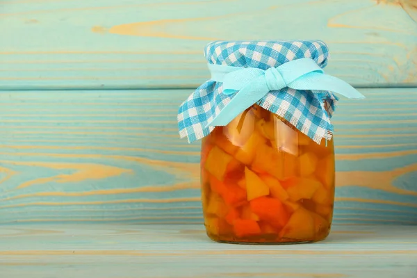 One jar of quince jam at blue vintage wood surface — Stock Photo, Image