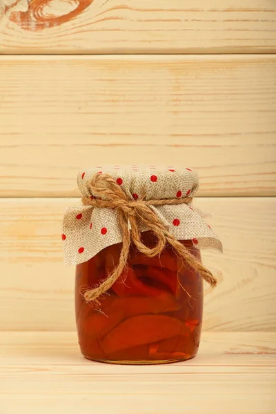 One jar of quince jam over vintage wood planks — Stock Photo, Image