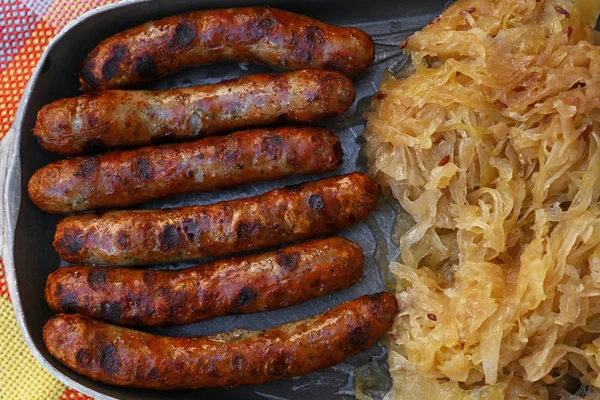 Close grilled Nuremberg sausages with sauerkraut — Stock Photo, Image