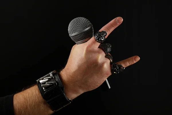 Man hand with microphone isolated on black — Stock Photo, Image