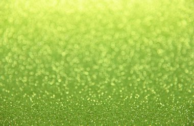 Yeşil Bokeh 'in soyut arkaplanı bulanık ışıklar ve parıltılar