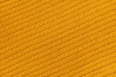 Sıcak sarı kablo örgü örülmüş örgü örülmüş örgü örgülü süveterin arka plan dokusunu kapatın.