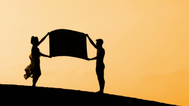 Silhouette dancing on a beach on sunset — Stock Video