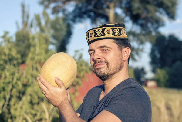 Young man with a ripe melon — Stock Photo, Image