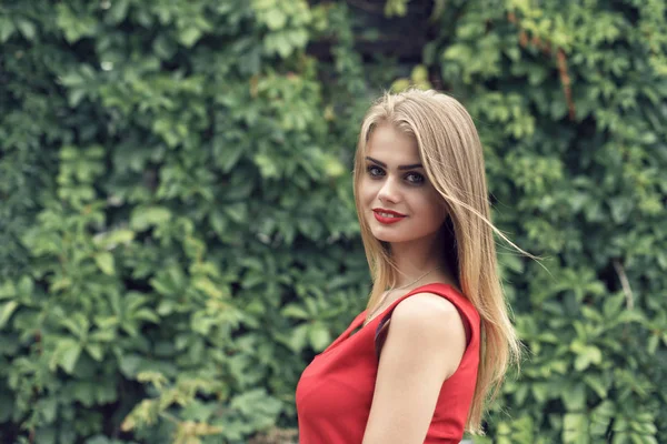 Blonde in bright red dress — Stock Photo, Image