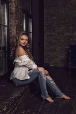 Çatı katı tarzında genç bir sarışının fotoğraf çekimi.