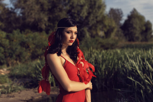 Young girl in red by the river
