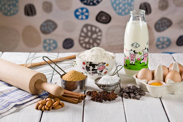 Ingredients for baking cake, on a wooden rustic background.