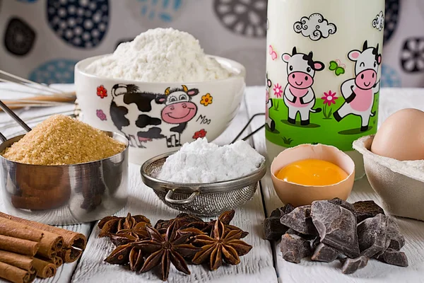 Ingredients for baking cake, on a wooden rustic background.