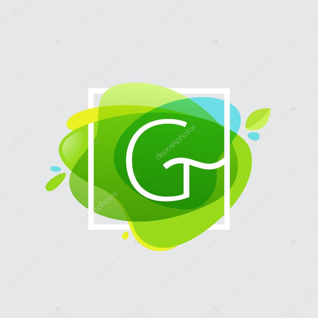G letter logo in square frame at green watercolor splash backgro