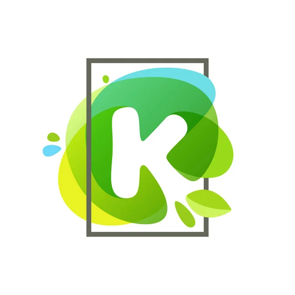K letter logo in square frame at green watercolor splash backgro — Stock Vector