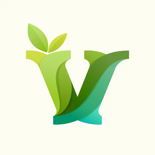 Swirling letter V logo with green leaves. — Stock Vector