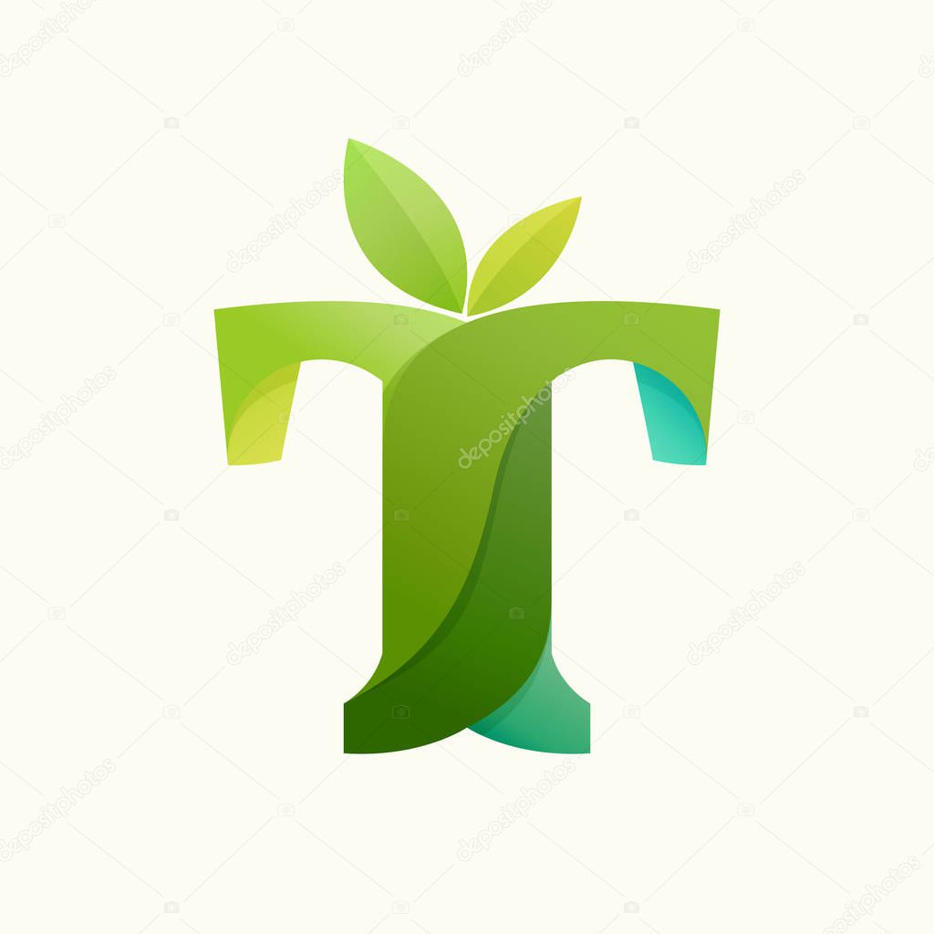 Swirling letter T logo with green leaves.