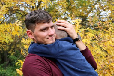 Babası tutan oğlu oğlu onun kollarında sarıldı