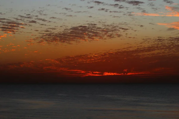 Muito bonito pôr-do-sol vermelho no inverno, céu nublado, raio de sol no mar de nuvens — Fotografia de Stock