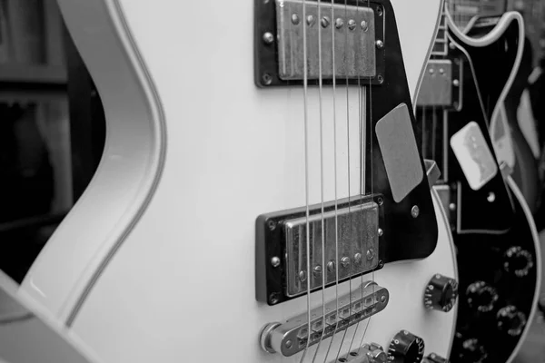 a large number of electric guitars on the counter in the store