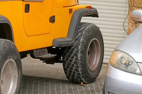 a big car wheel yellow car