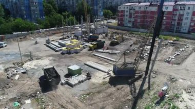 Construction site with a bird's eye in a megacity. New house in a new residential complex. Flying over the construction site. aerial panoramic top view from hight copter drone flying sky footage