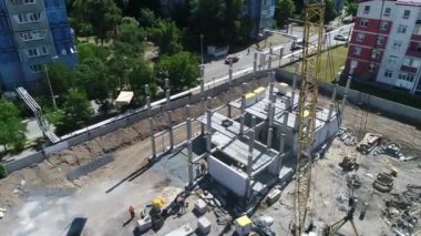 Construction site with a bird's eye in a megacity. New house in a new residential complex. Flying over the construction site. aerial panoramic top view from hight copter drone flying sky footage