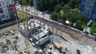 Construction site with a bird's eye in a megacity. New house in a new residential complex. Flying over the construction site. aerial panoramic top view from hight copter drone flying sky footage