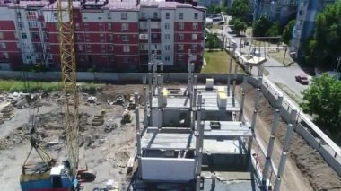 Construction site with a bird's eye in a megacity. New house in a new residential complex. Flying over the construction site. aerial panoramic top view from hight copter drone flying sky footage
