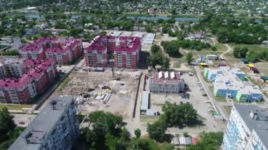 Construction site with a bird's eye in a megacity. New house in a new residential complex. Flying over the construction site. aerial panoramic top view from hight copter drone flying sky footage