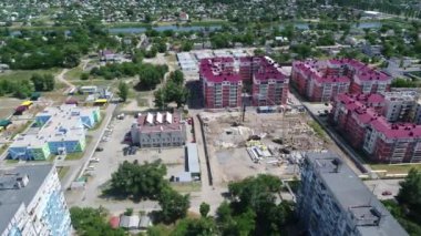 Construction site with a bird's eye in a megacity. New house in a new residential complex. Flying over the construction site. aerial panoramic top view from hight copter drone flying sky footage