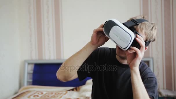 Young Man Using VR-Helmet Plays a Game — Stock Video