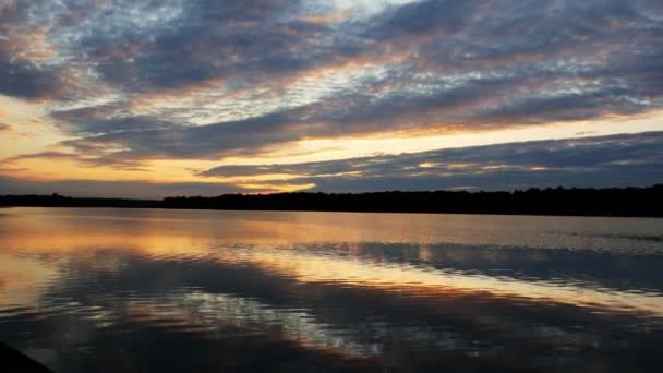 Dramáticas nubes y puesta de sol sobre amplio lago, paisaje — Vídeos de Stock