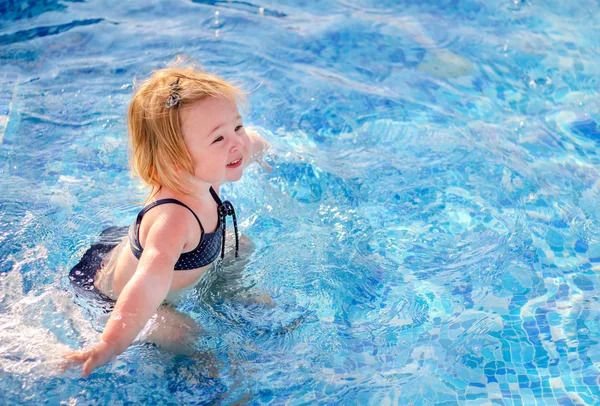 stock image Baby girl playing in pool