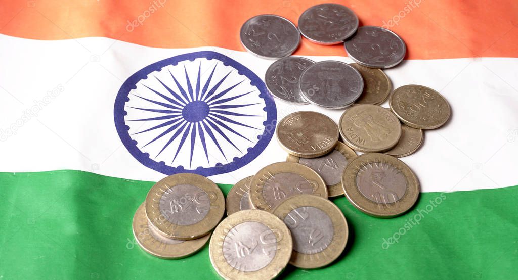 GST concept, indian coins on Indian Flag background, business and financial india. Investment Saving and Corruption.