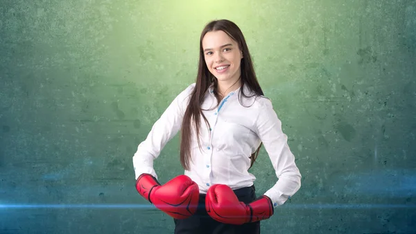 Young beautiful woman dress in white shirt standing in combat pose with red boxing gloves. Business concept. — Stock Photo, Image