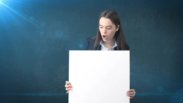 Ritratto donna d'affari sorpreso con bordo bianco bianco bianco su blu isolato. Modello femminile con capelli lunghi . — Foto Stock