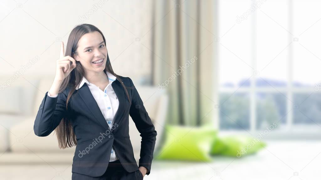 Young beautiful business woman and creative designer standing over blured interior background