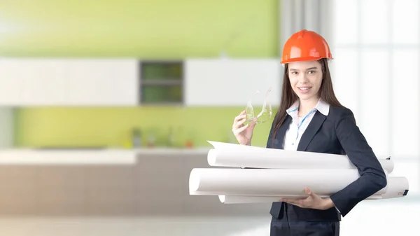 Young beautiful business woman and creative designer standing over blured interior background — Stock Photo, Image