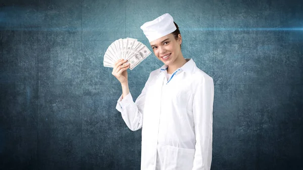 Beautiful medical woman doctor in uniform. Studio painted background. Concept of profitable health care. — Stock Photo, Image