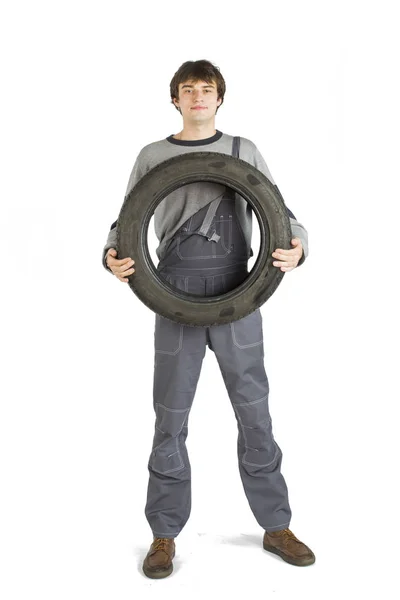 A young brunet foreman in working grey uniform with black wheel. — Stock Photo, Image