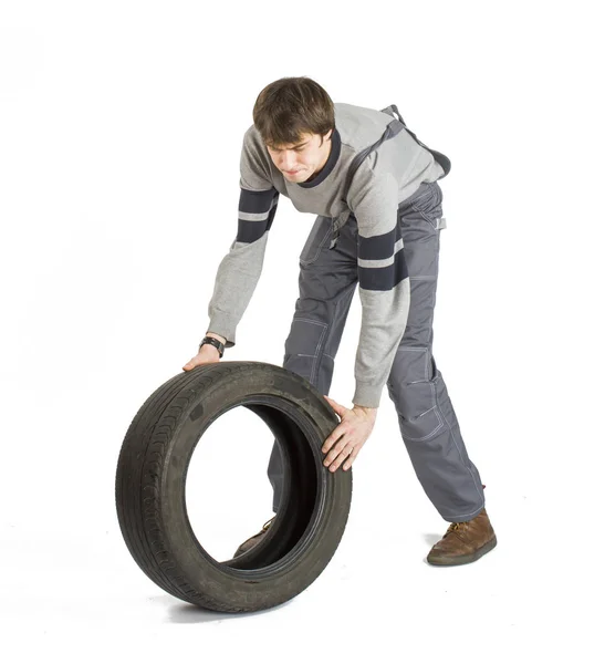 Un joven capataz de morena en uniforme gris con rueda negra . —  Fotos de Stock