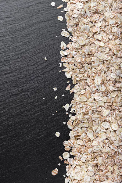 Raw oatmeal is scattered — Stock Photo, Image