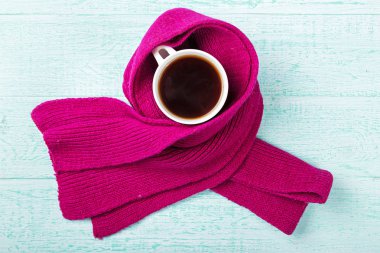 cup of hot black tea with steam in  knitted scarf clipart