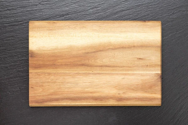Wooden board on a black background — Stock Photo, Image