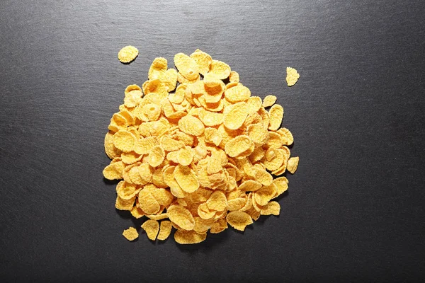 Corn flakes on a black background