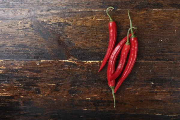 Red pepper on a brown wooden table — Stock Photo, Image