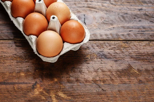 red chicken eggs on a wooden background