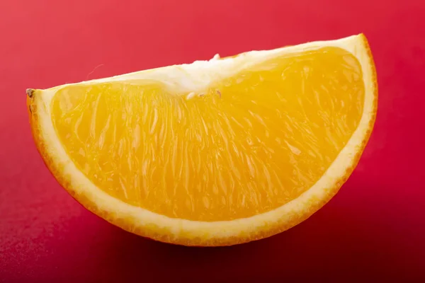Sliced orange on a red background. — Stock Photo, Image