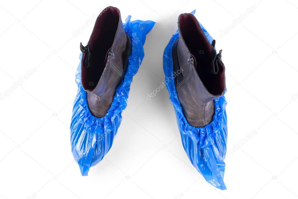 boots in blue shoe covers on a white background