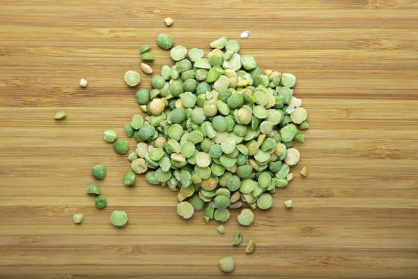 Dried green peas on a cutting board.