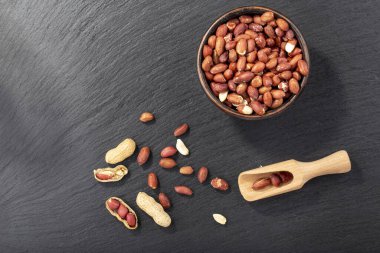 Kara tahtanın üzerindeki kil kasede yer fıstığı. Yukarıdan bak. Metin için yer.