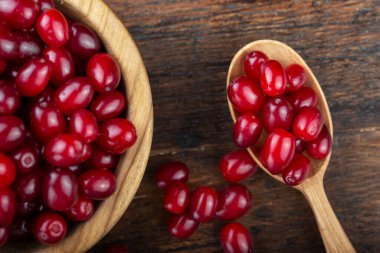 fresh dogwood in a white plate on a black background. place for tex